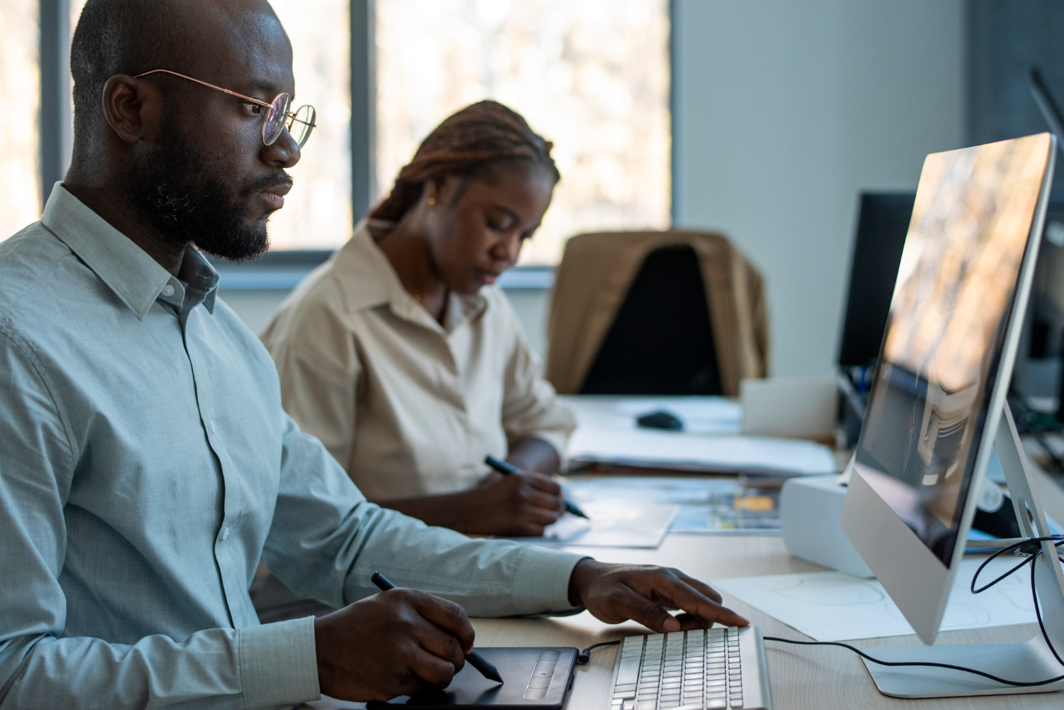 black-man-and-woman-working-with-computer-softwares